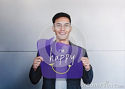 Happy Person Concept. Young Man Smiling and Show I am Happy Text on Speech Bubble Card. Positive Human Face Expression. Good Stock Photo