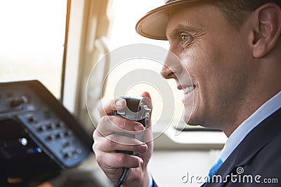 Happy pilot talking by portable radio set Stock Photo