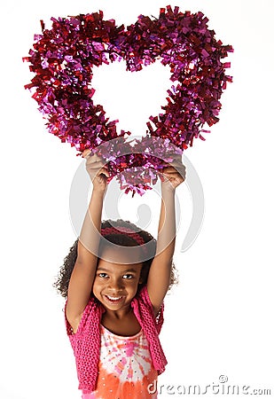 Happy playful child holding heart shape Stock Photo