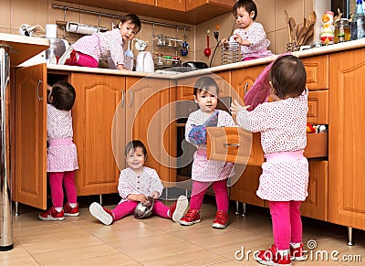 Happy playful girl playing in the kitchen Stock Photo