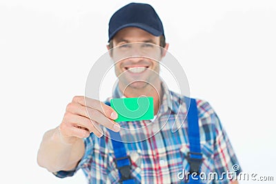 Happy plumber showing green card Stock Photo