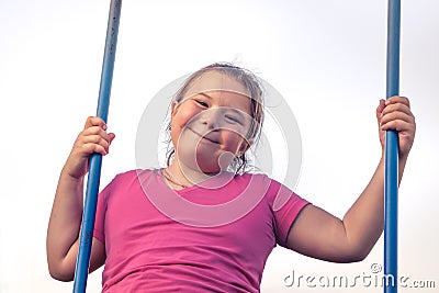Happy plump child girl fun swinging sky happy carefree childhood Stock Photo