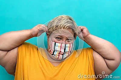 Happy plus size woman wearing face mask portrait - Curvy overweight model having fun posing in front camera Stock Photo