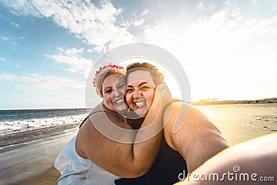 Happy plus size women taking selfie on the beach - Curvy overweight girls having fun during vacation in tropical destination Stock Photo