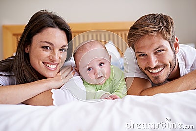 Happy portrait of mother, father and baby on bed for love, care and fun quality time together at home. Parents, cute Stock Photo