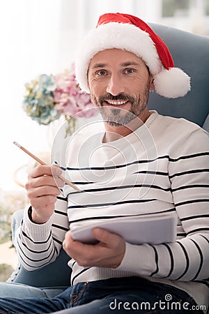 Happy positive man holding a pencil Stock Photo