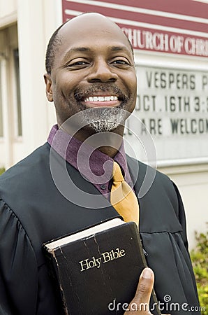 Happy Preacher Holding Holy Bible Stock Photo