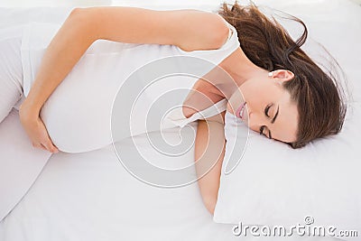 Happy pregnancy is lengthened on his bed Stock Photo