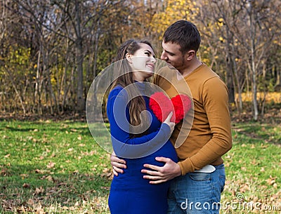 Happy pregnant couple hugging each other Stock Photo