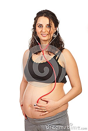 Happy pregnant listening baby Stock Photo