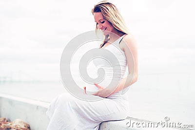 Happy pregnant woman bonding with her unborn child Stock Photo