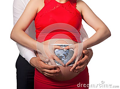 Happy pregnant woman and her husband with sonogram scan of their Stock Photo