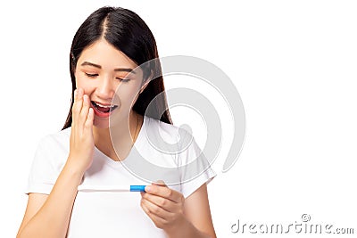 Happy pregnant woman holding pregnancy test and get surprise because single mother has baby with smiley face. Young Mother waiting Stock Photo