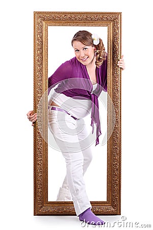 Happy pregnant woman out of large carved frame Stock Photo