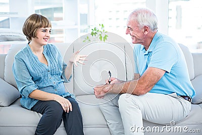 Happy pregnant woman talking to gynaecologist Stock Photo