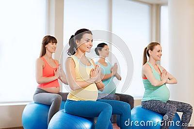 Happy pregnant women exercising on fitball in gym Stock Photo