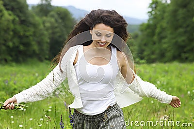 Happy pretty brunette woman in chamomile field, cute female relaxed on flowers meadow Stock Photo