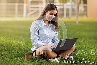 Happy pretty millennial caucasian lady enjoy work, cup of coffee takeaway Stock Photo