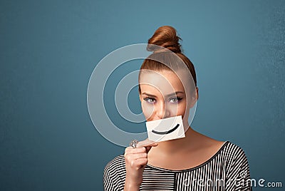 Happy pretty woman holding card with funny smiley Stock Photo