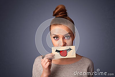 Happy pretty woman holding card with funny smiley Stock Photo