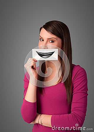 Happy pretty woman holding card with funny smiley Stock Photo