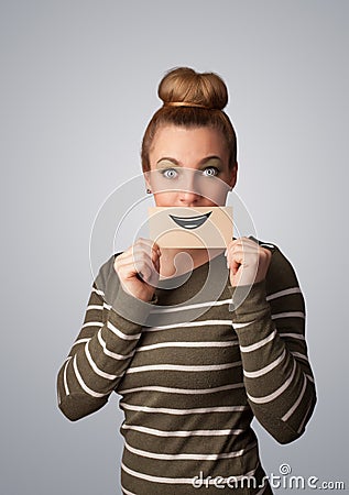 Happy pretty woman holding card with funny smiley Stock Photo