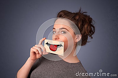 Happy pretty woman holding card with funny smiley Stock Photo