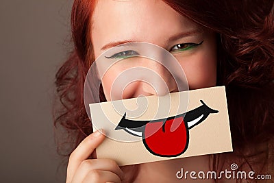 Happy pretty woman holding card with funny smiley Stock Photo