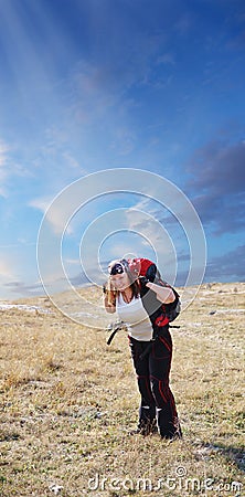 A happy and pretty woman spends her free time backpacking and ge Stock Photo