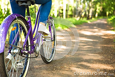 Happy pretty young girl bicycling on summer park. Happy relax time in city. Beautiful woman, sunny day Stock Photo