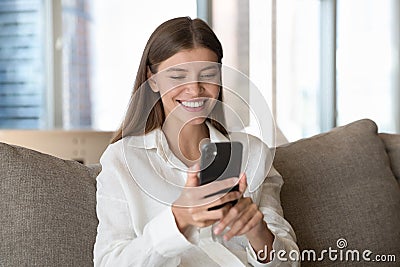 Happy pretty young smartphone user woman talking on video call Stock Photo