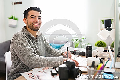 Portrait of a smiling latin man working as a photographer Stock Photo