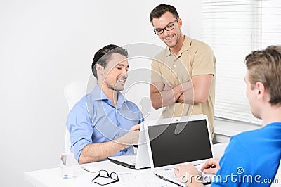 Happy with the project results. Three business people working on Stock Photo