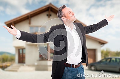 Happy realtor standing outside with arms outstretched Stock Photo