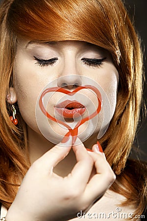 Happy redhair girl with heart love symbol Stock Photo