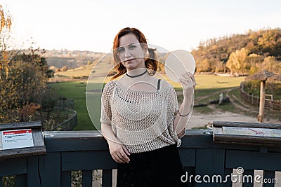 Happy redhead woman enjoys tradicional czech sweet waffer food Oplatky in the Pragu Zoo Stock Photo