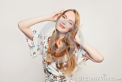 Happy redhead woman with headphones on white Stock Photo