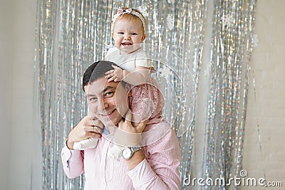 Happy relationship of handsome dad and cute daughter having fun at home. Portrait of father and toddler girl celebrate and enjoy Stock Photo