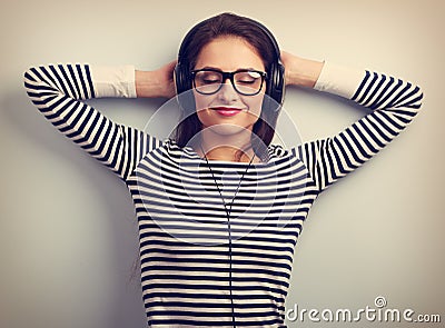 Happy relaxing young woman in headphones listening the calm musi Stock Photo