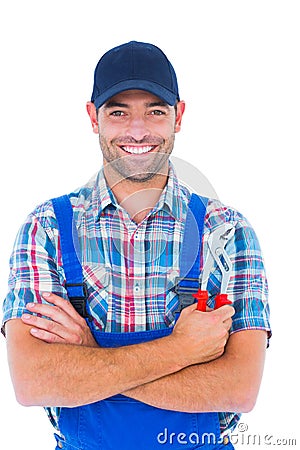 Happy repairman holding pliers on white background Stock Photo