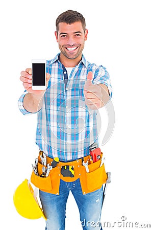 Happy repairman showing mobile phone white gesturing thumbs up Stock Photo