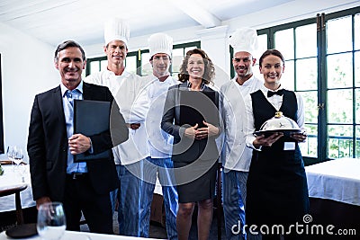 Happy restaurant team standing together in restaurant Stock Photo