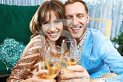 Happy romantic couple clinking glasses with sparkling wine, enjoying evenrning party, having date at Valentine`s Day. Stock Photo