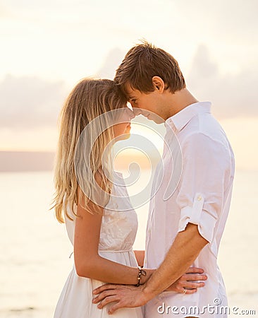 Happy romantic couple having loving moment touching foreheads Stock Photo