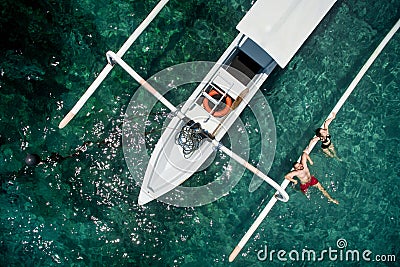 Happy romantic couple in love relax near a yacht in the sea while honeymoon Stock Photo