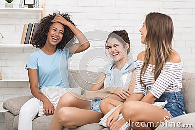 Happy roommates having friendly talk at home Stock Photo
