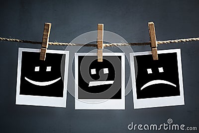 Happy, sad and neutral emoticons on instant print photographs Stock Photo