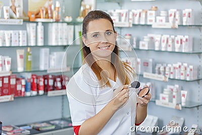 Happy sales assistant in beauty product shop Stock Photo