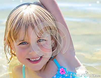 Happy, Sandy Little Girl in the Lake Stock Photo
