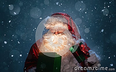 Happy Santa Claus opening christmas gift box Stock Photo